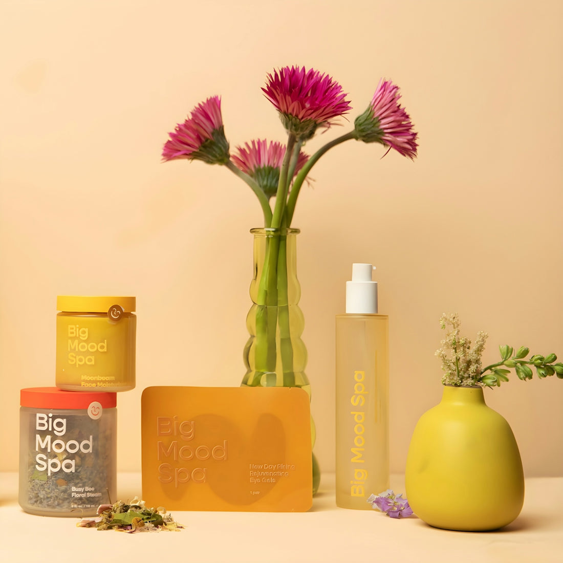 Spa products and flowers on a peach background